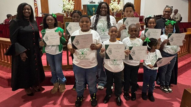 Buds of Promise children with their certificates in the sanctuary