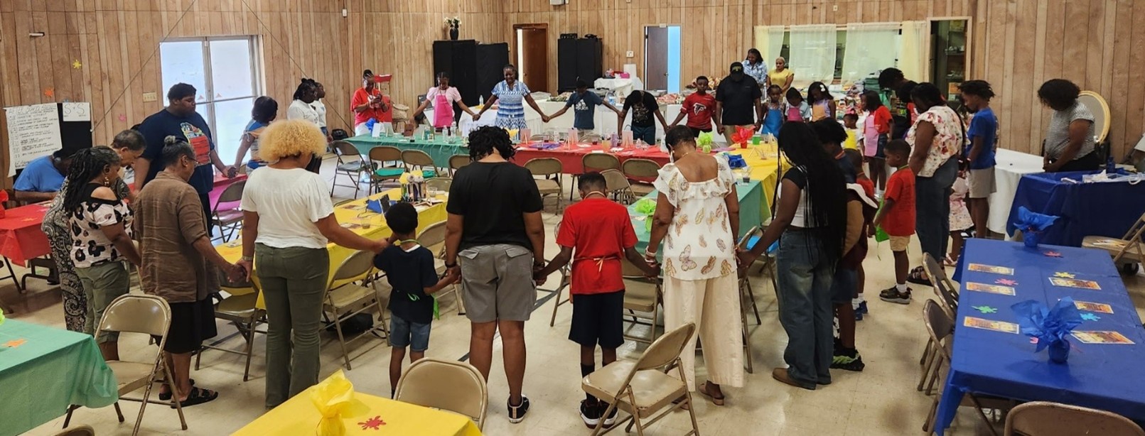 Members joining hands in prayer during a church gathering